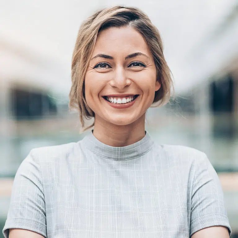 Smiling woman with her arms crossed