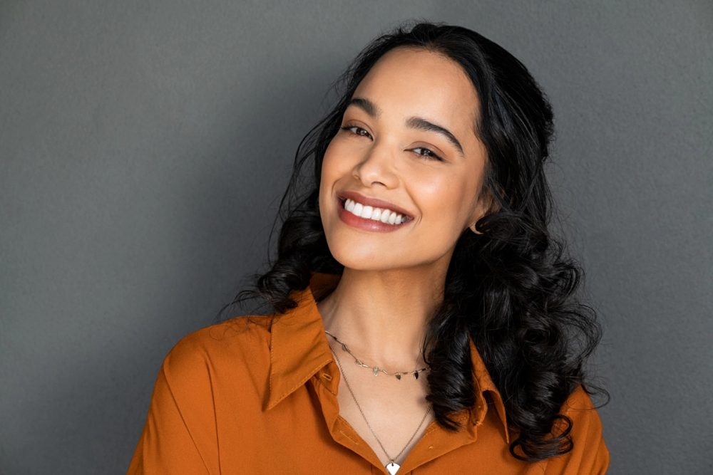 Smiling woman wearing an orange top